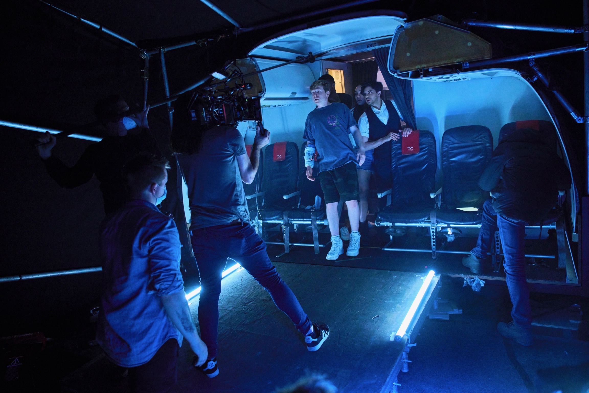 A group of people filming inside a submerged airplane