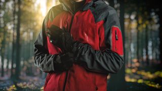 a photo of a male wearing a waterproof jacket and gloves