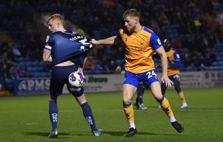 Carlisle player Morgan Feeney is challenged by Mansfield player Alfie Kilgour during the Sky Bet League Two between Carlisle United and Mansfield Town at Brunton Park on February 14, 2023 in Carlisle, England. (Photo by Stu Forster/Getty Images)