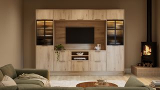 living room with built in media wall in pale wood and log burner on raised platform in corner of room