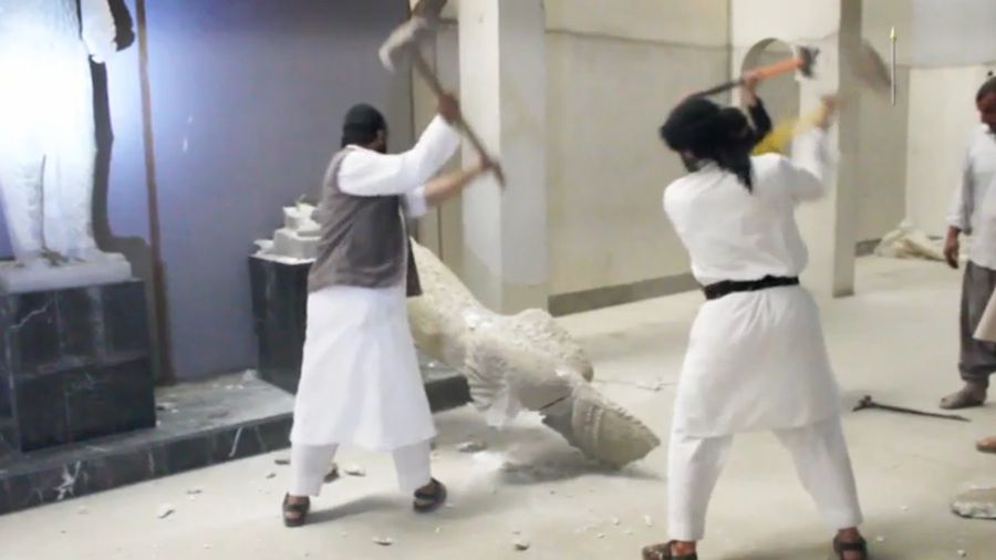 ISIS militants destroy two statues of kings from the ancient city of Hatra. 