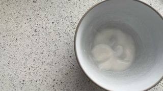 a bowl of water and bicarbonate of soda on a quartz worktop