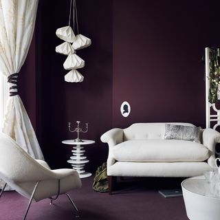 living area with white sofa and deep aubergine colour wall