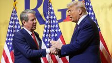 WASHINGTON, DC - FEBRUARY 20: U.S. President Donald Trump shakes hands with Gov. Brian Kemp (R-GA) as he delivers remarks at the Republican Governors Association Meeting at The National Building Museum on February 20, 2025 in Washington, DC. Trump discussed his legislative agenda in his remarks. (Photo by Win McNamee/Getty Images)