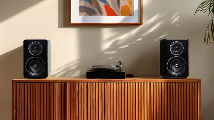 Jamo speakers with turntable on a cabinet