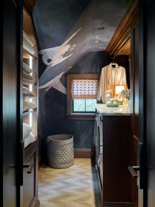 a dark laundry room with wallpaper