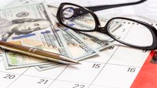 picture of money, glasses and a pen on a calendar