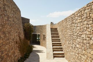 ridge house stone walls and external landscaping levels arrangement