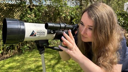 The author looking through a Celestron Moon Mission Travel-scope 70. 