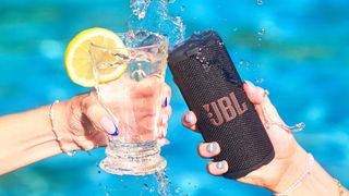 JBL Grip toasting with a drink