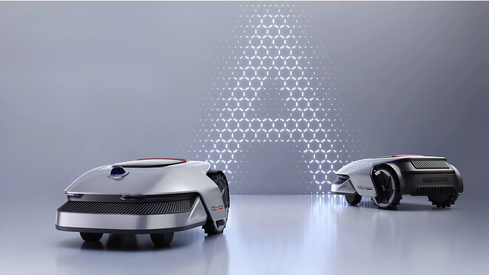 A pair of Dreame Roboticmower A1 lawn mowers in a grey background