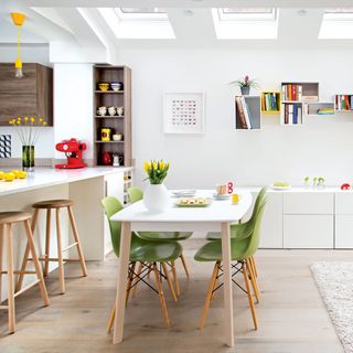 kitchen and dining area with white walls and dining table