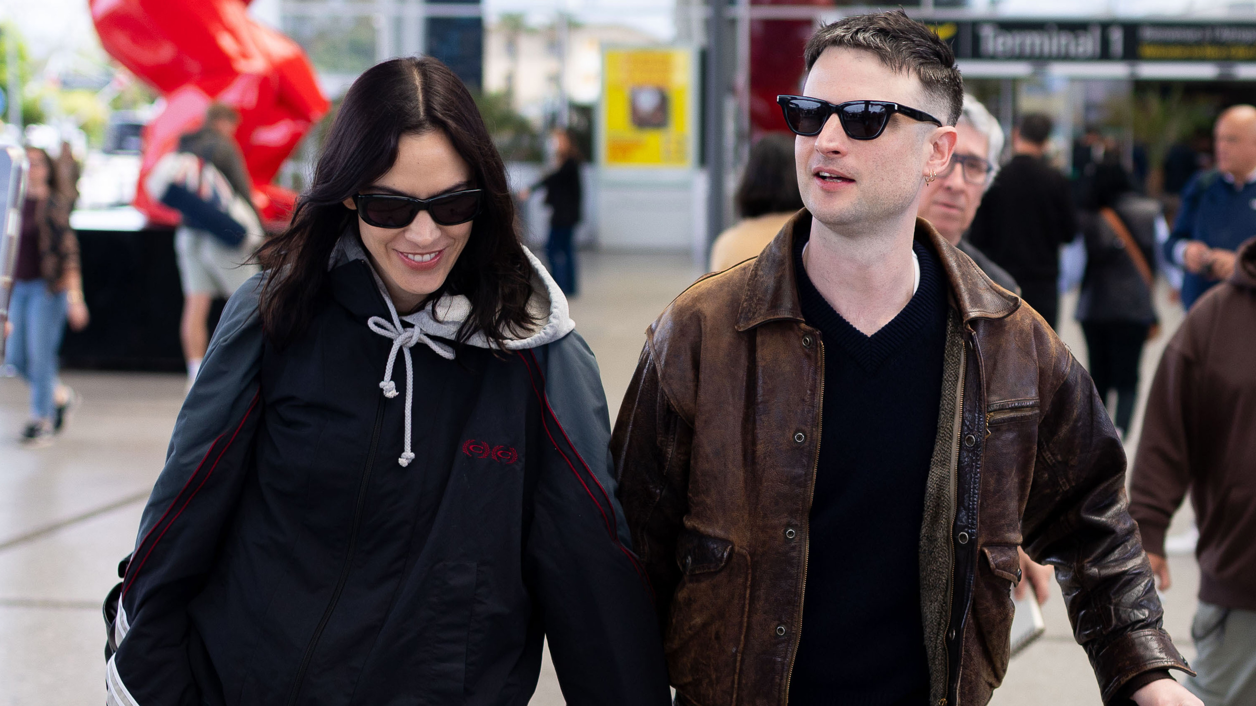 Alexa Chung and Tom Sturridge at the Cannes Airport in France wearing relaxed jeans and patent-leather flats. 