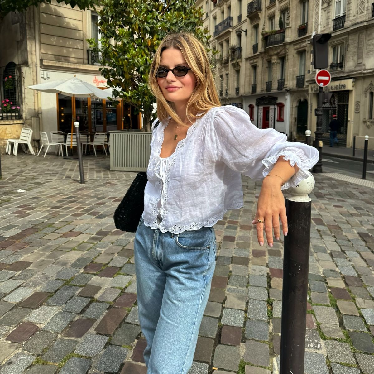 An image of @sabinasoco wearing a white blouse and jeans, two of the biggest French fashion staples,  whilst in Paris.