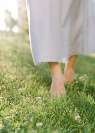 Woman walking barefoot in the garden