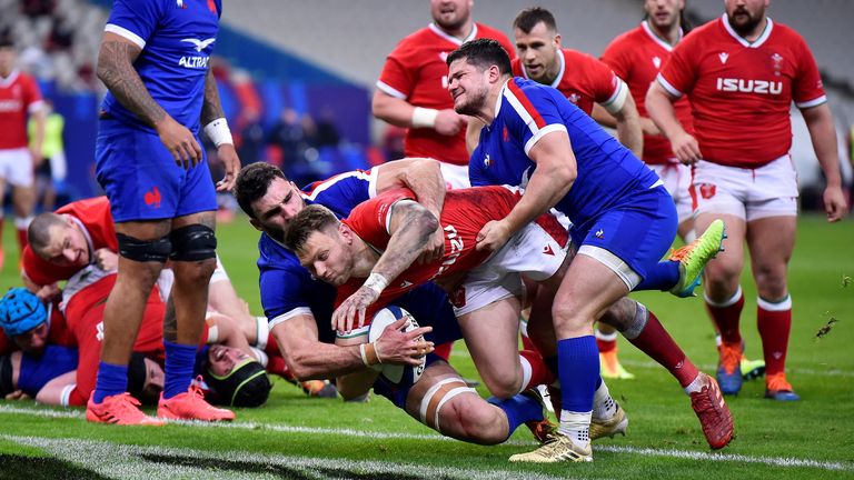 Dan Biggar of Wales scores his sides 1st try as Charles Ollivon and Julien Marchand of France attempt to tackle during the Guinness Six Nations match between France and Wales