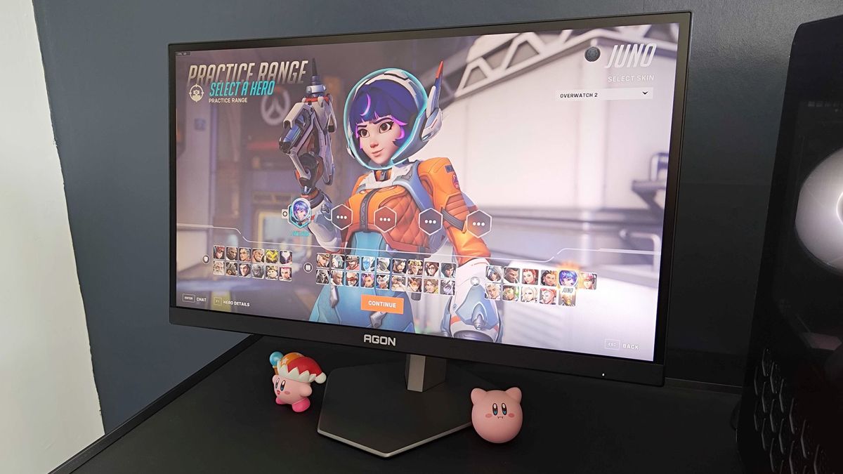 AOC AGON Pro AG246FK sitting on desk with Overwatch 2 character screen on display and character Juno selected