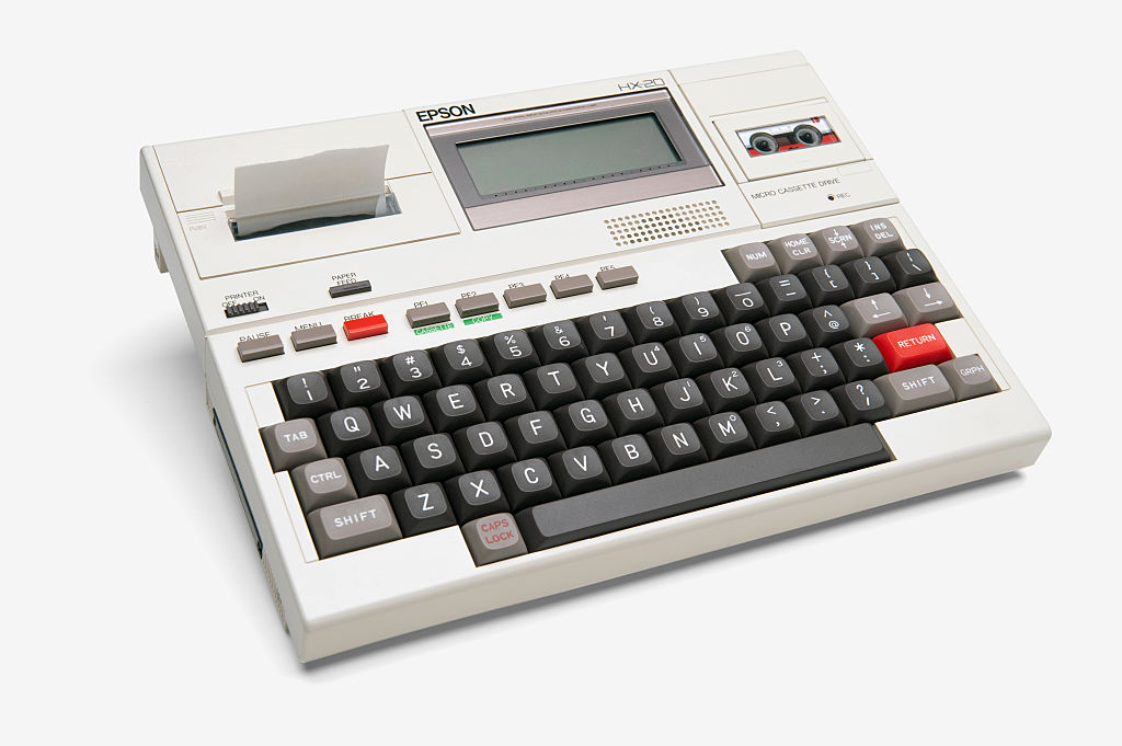 A vintage 1980's Epson HX-20 laptop computer, on a white background.
