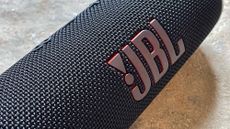 Listing image for Best JBL Speakers showing JBL Flip 6 speaker - close up of branding and speaker grille
