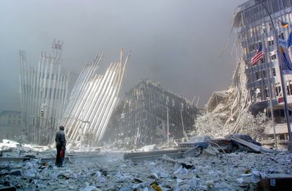 A man, standing amid the rubble of the World Trade Centers on Sept. 11, calls out, asking if anyone needs help.