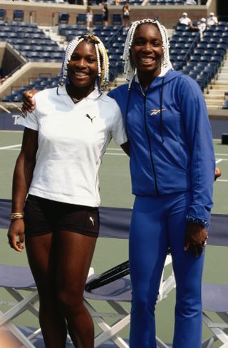 Serena and Venus Williams wearing braids with beads on a tennis court