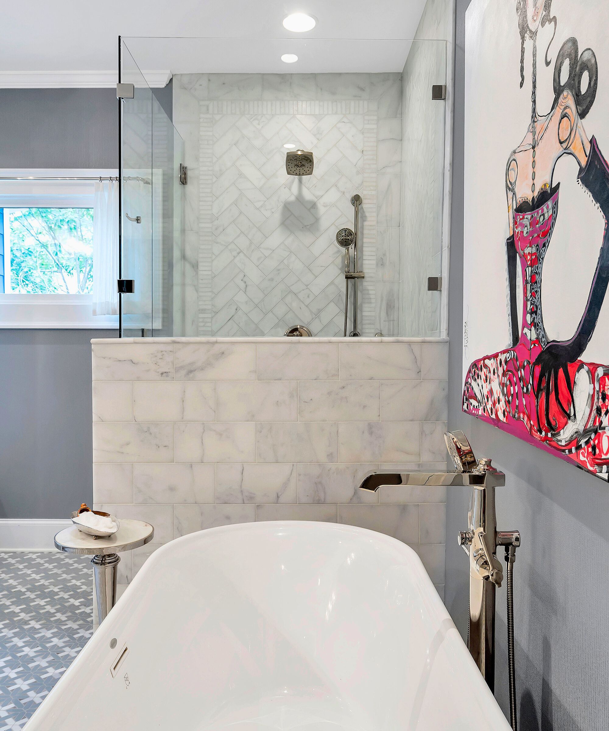 Gray bathroom with tiled shower, freestanding tub and large graphic art on the wall