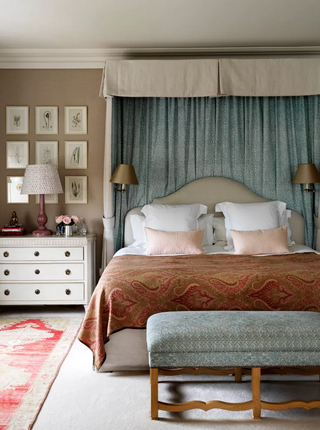 duck egg blue bed canopy and bench seat, coffee-colored walls and burnt orange paisley print throw