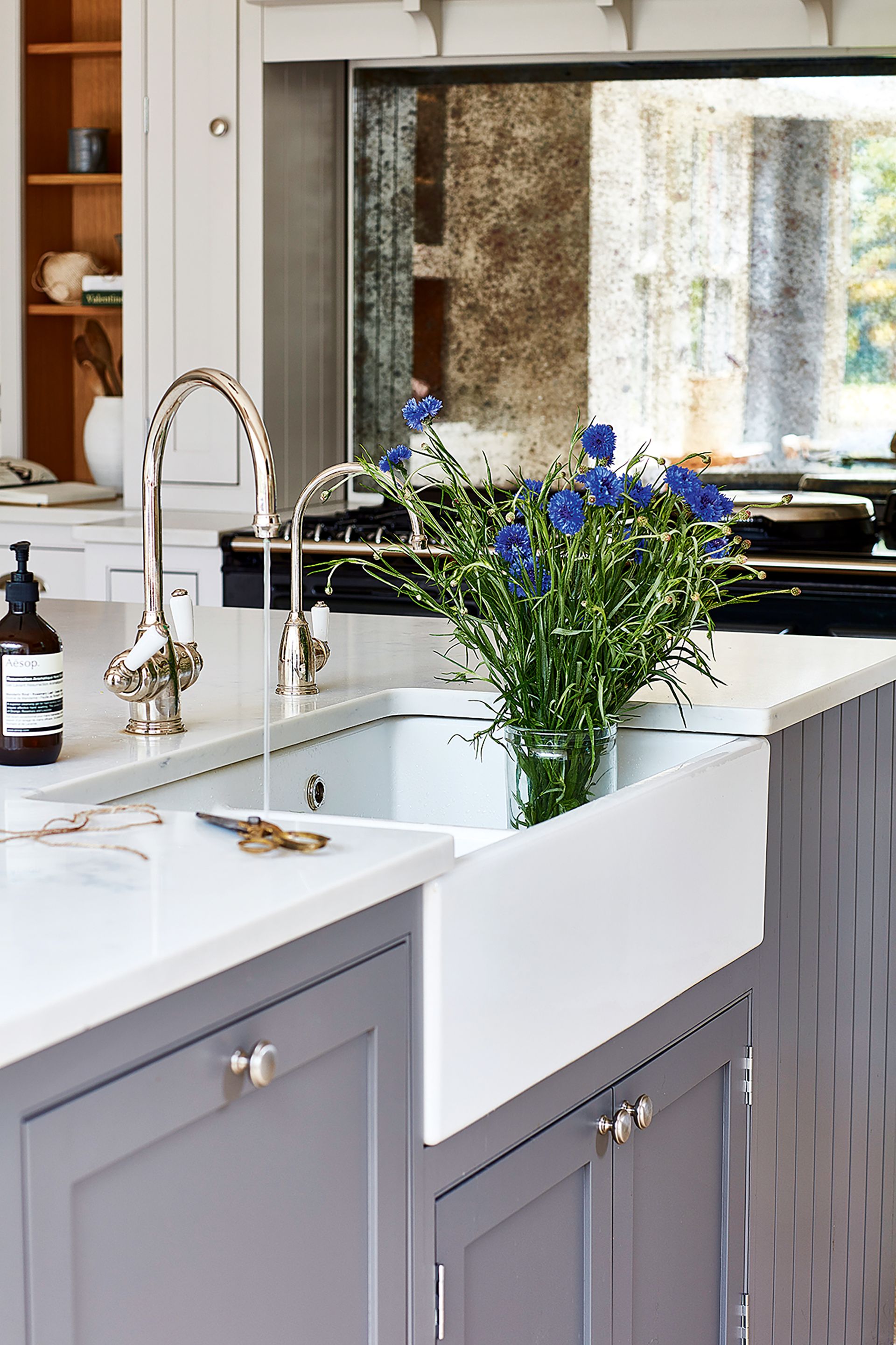 butler sink in kitchen with grey cabinetry