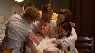Trixie Franklin (Helen George) in a robe surrounded by the other nurses in Call the Midwife