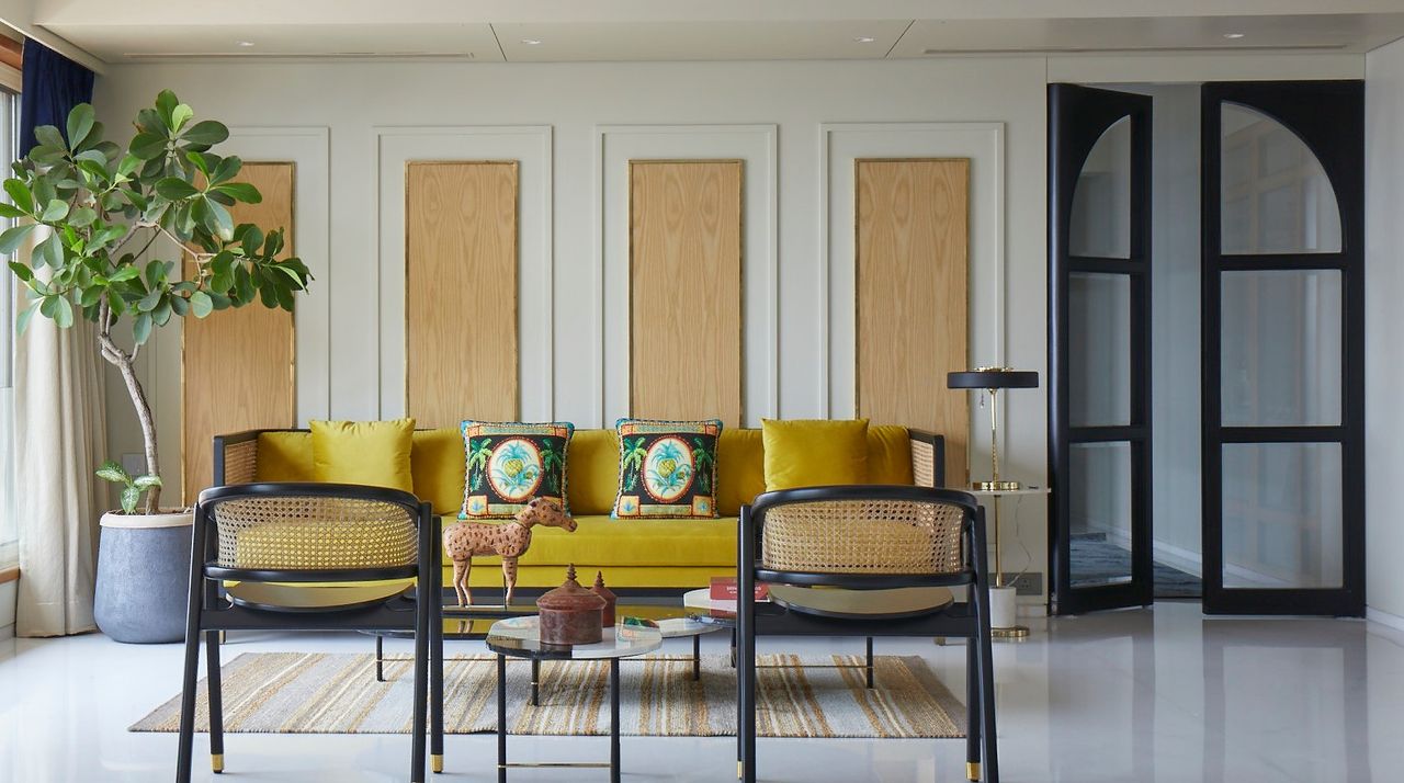 A living room with wall panels and a tall plant