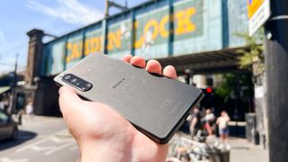 The Sony Xperia 1 IV lying in a hand, from the back