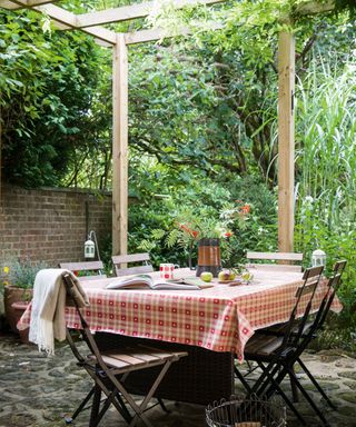 simple pergola structure with table and chairs