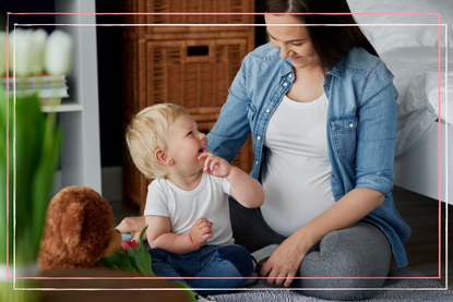 Pregnant women in her 40s playing with a toddler 