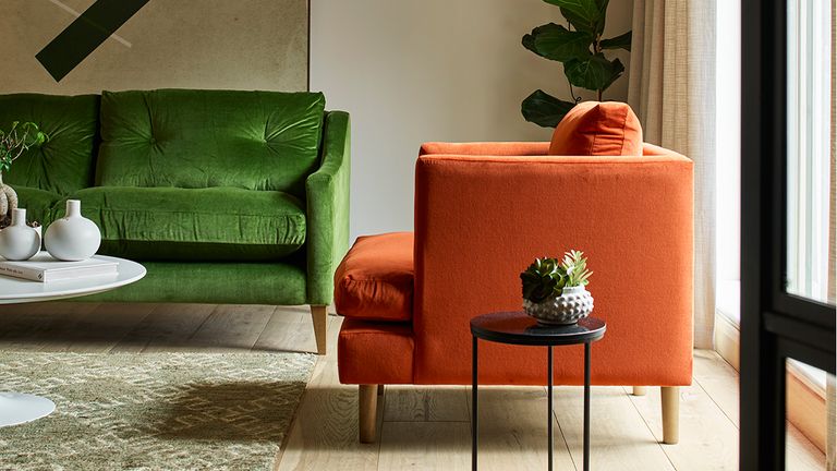 Living room with orange and green velvet sofas