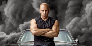 Vin Diesel standing in front of car in F9 poster