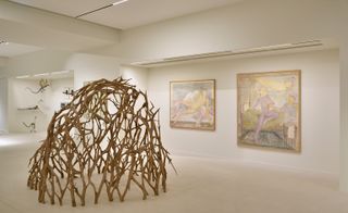 wooden branch dome sculpture in white art gallery