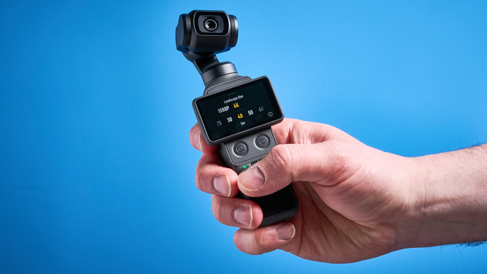 DJI Osmo Pocket 4 against a blue background