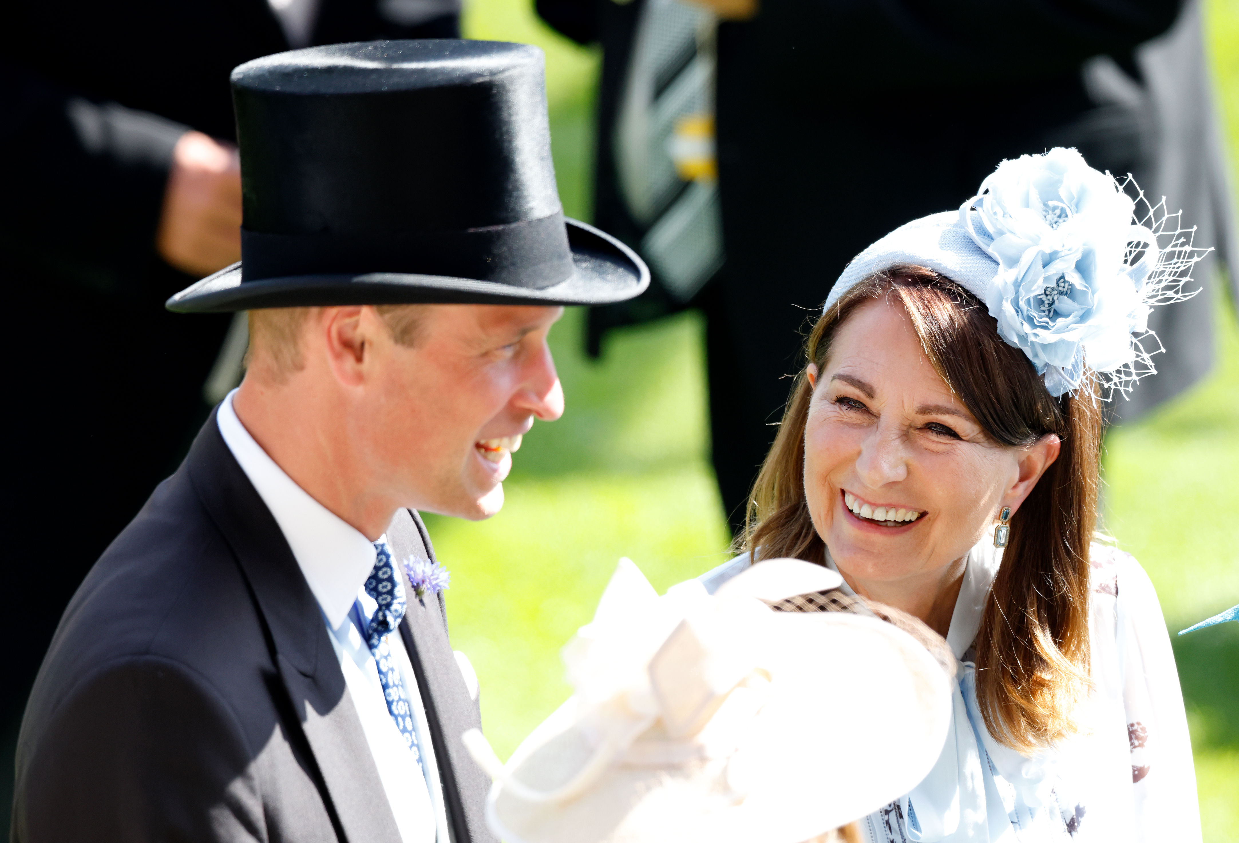 Prince William and Carole Middleton at Royal Ascot smiling and looking at each other