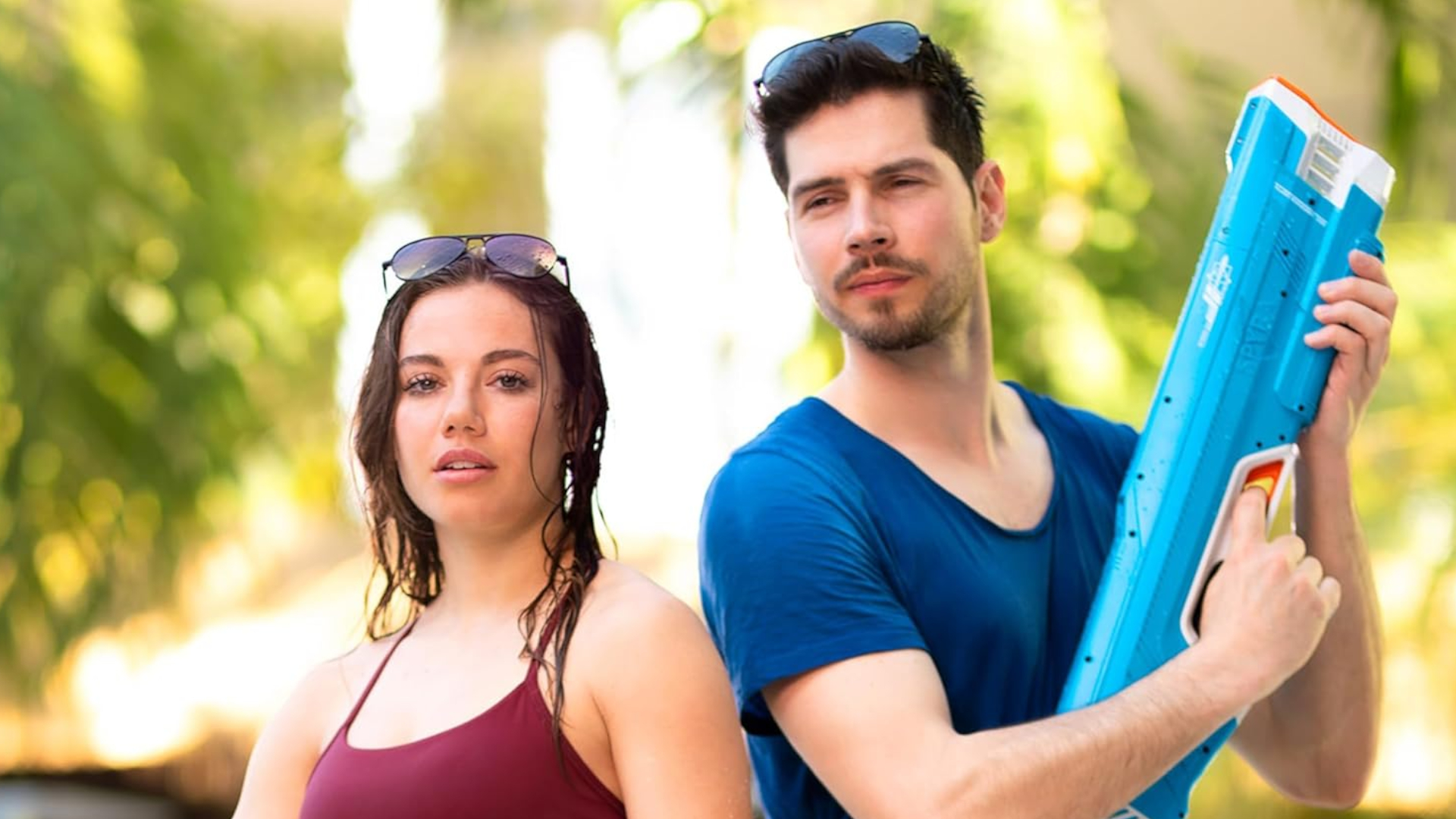 Two adults holding SpyraThree blasters, looking serious
