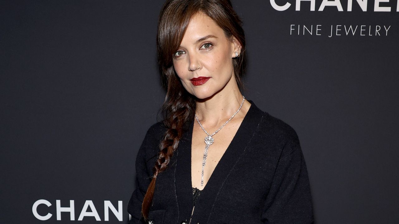 Katie Holmes in front of a step and repeat 