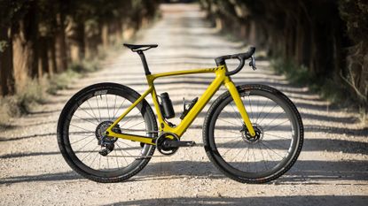 The Scott Solace Gravel eRide 10 bike in yellow on a white gravel path