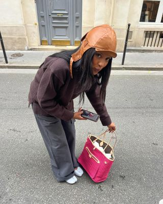 Fashion influencer  @mv.tiangue wearing a chic winter outfit in Paris with the controversial Tabi ballerina trend.