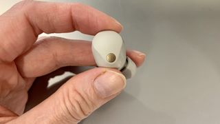 Sony WF-1000XM5 earbud held in a hand