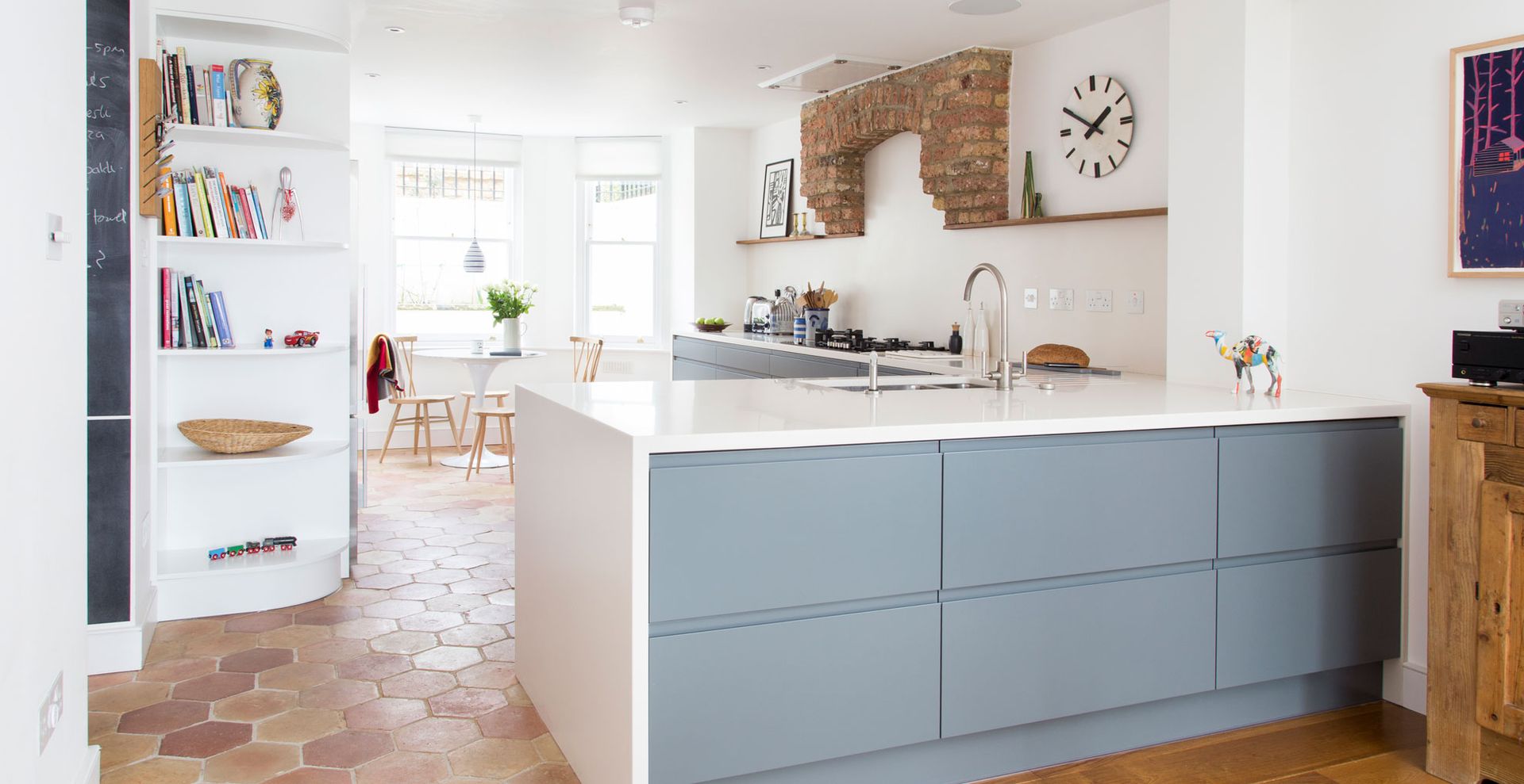 Kitchen with blue units and white walls