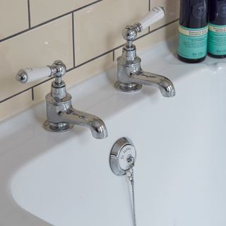 White sink with silver taps with tiles
