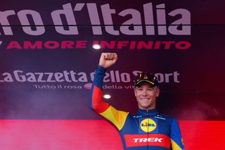 Team Lidl-Trek's Italian rider Jonathan Milan celebrates on the podium after winning the 4th stage of the 107th Giro d'Italia cycling race, 190 km between Acqui Terme and Andora, on May 7, 2024 in Andora. Milan won the stage ahead of Team Alpecin's Australian rider Kaden Groves and Team Bahrain's German rider Phil Bauhaus. (Photo by Luca Bettini / AFP)