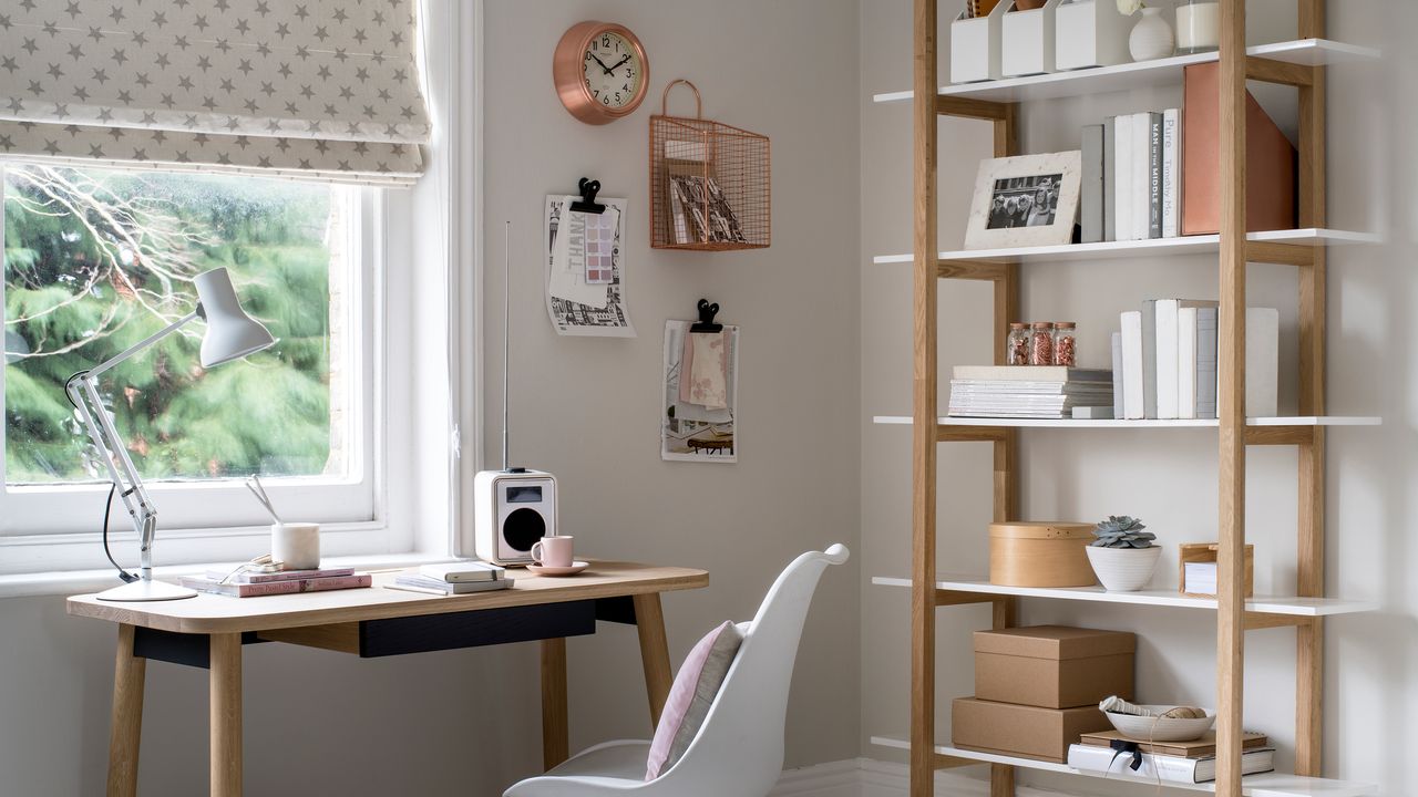 Neutral home offie with freestanding bookshelves and desk