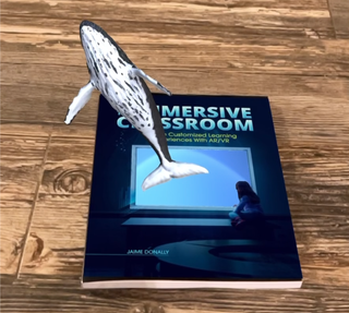 The cover of Jaime Donally's book with a whale rising out of it as part of an immersive experience.