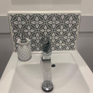 bathroom with washbasin and tile sticker