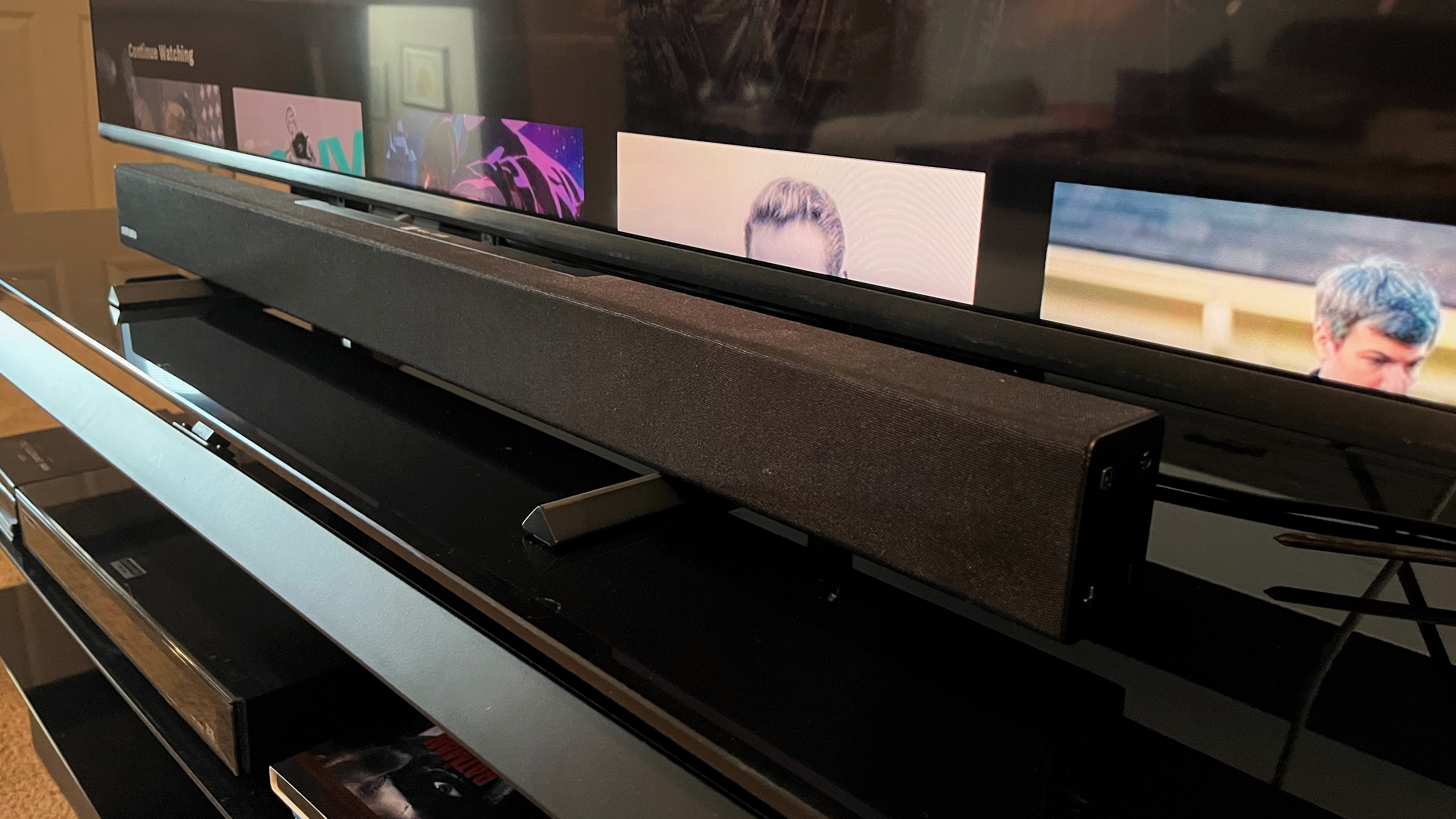 Vizio M65QXM on TV stand showing soundbar mount